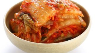 A bowl of kimchi on a white background