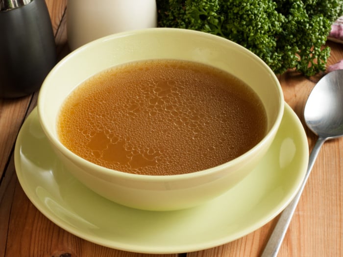 A close-up view of bone broth in a bowl